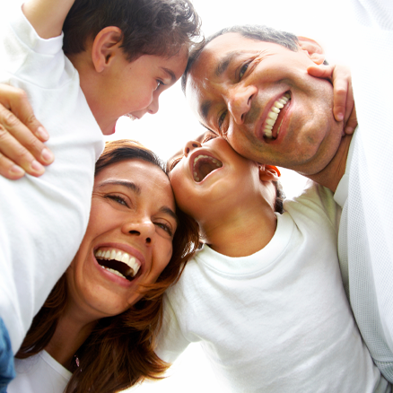 Family members in a huddle, smiling.